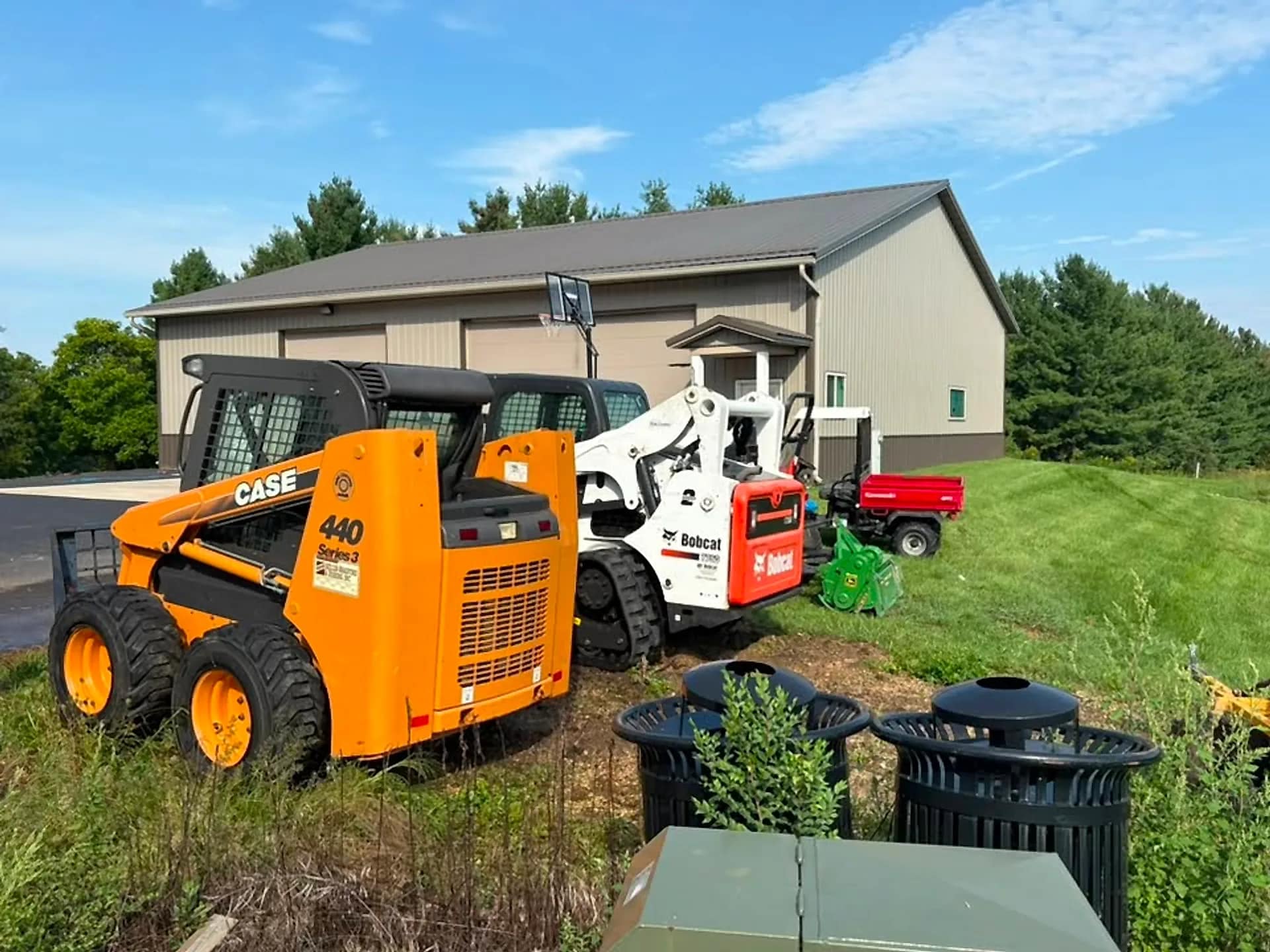 A Case skid steer and Bobcat washed down on site, paintwork clean