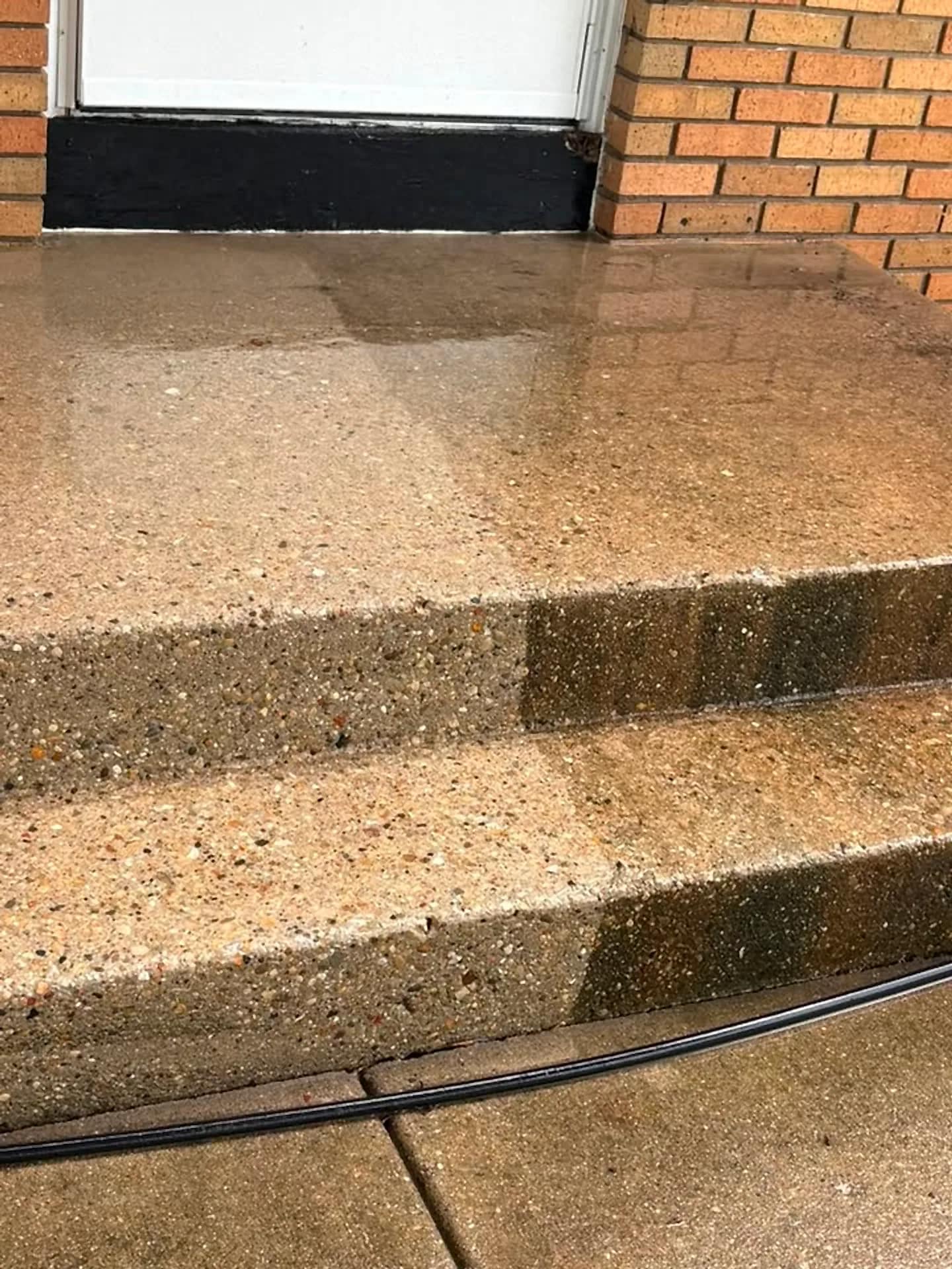Concrete steps mid-clean, treads bright against the untouched riser