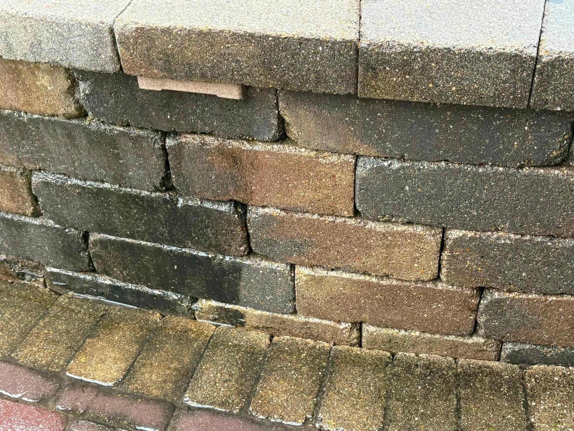 Block wall course washed clean, sharp division from the weathered section